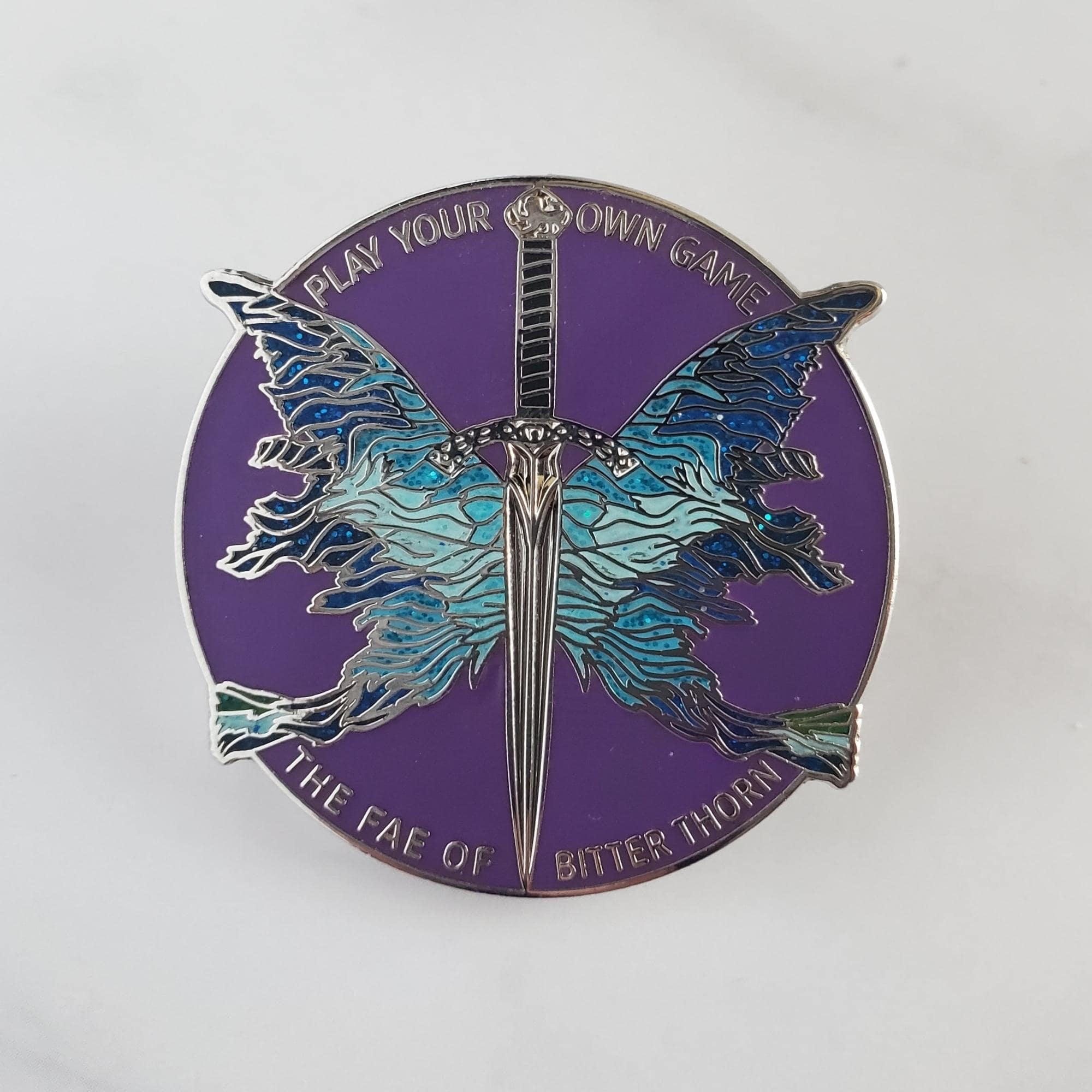 Enamel Pin with Wings and Sword from The Fae of Bitter Thorn series